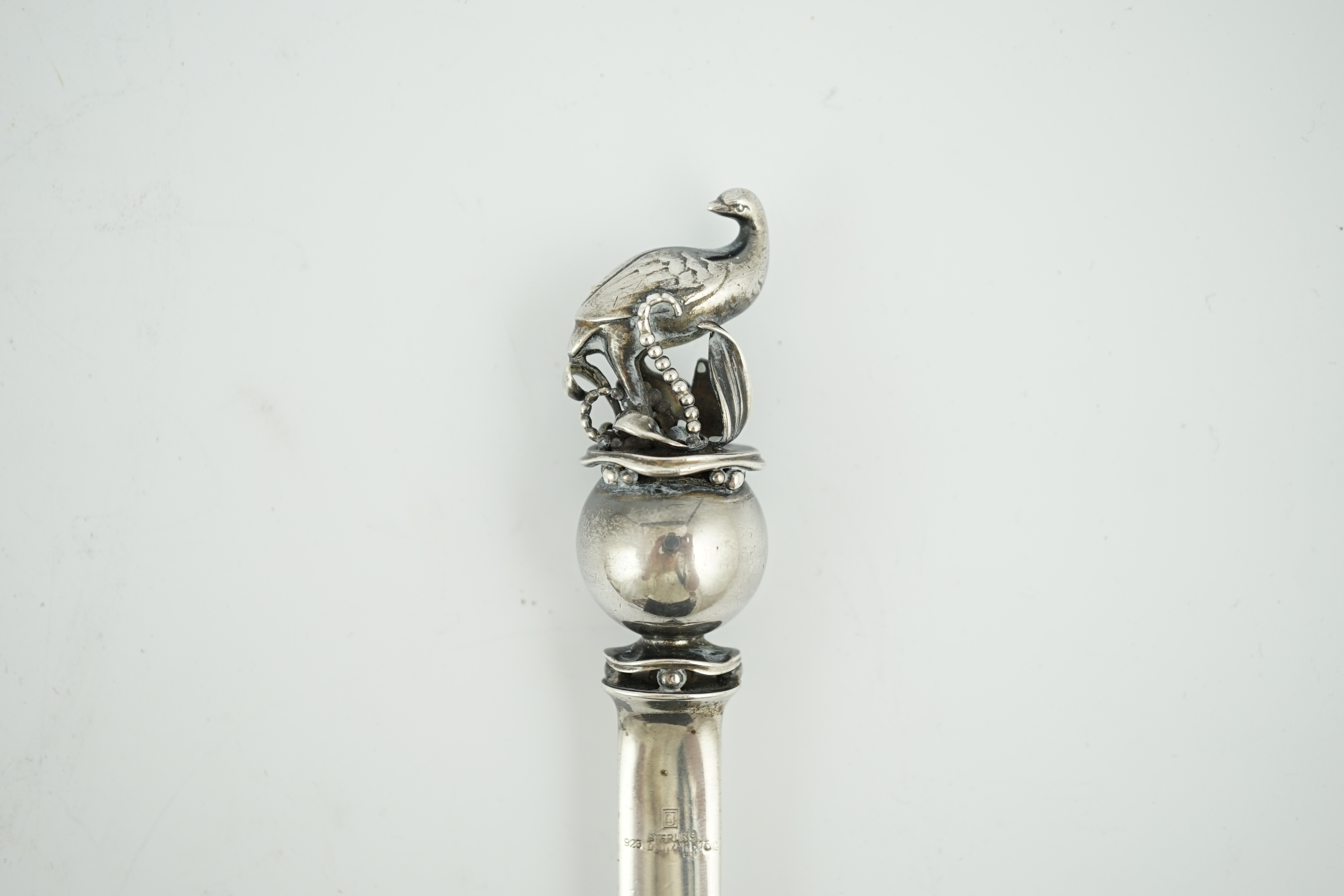 A Georg Jensen sterling silver letter opener, with game bird and sphere finial